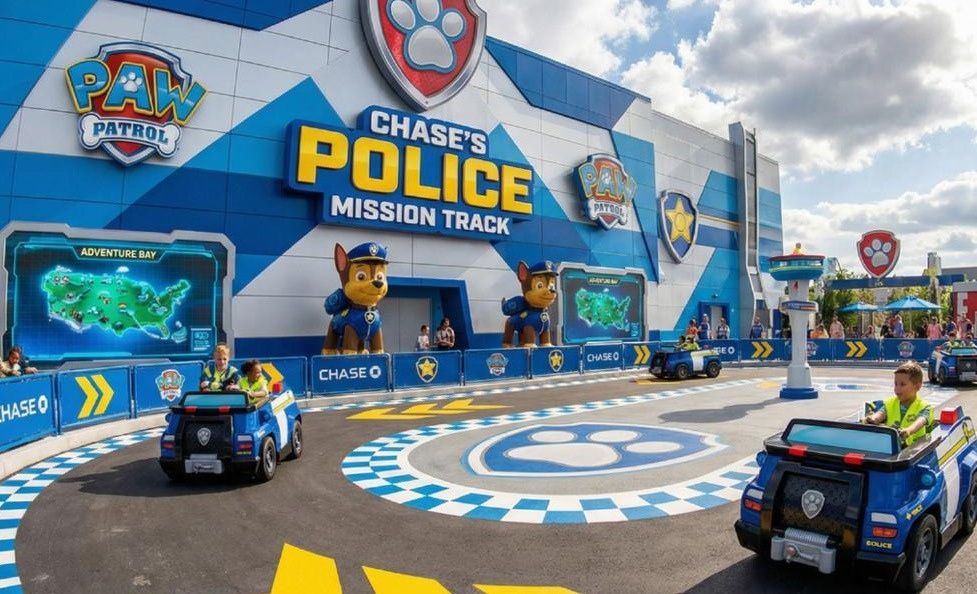 Children driving character police vehicles on a themed mission track